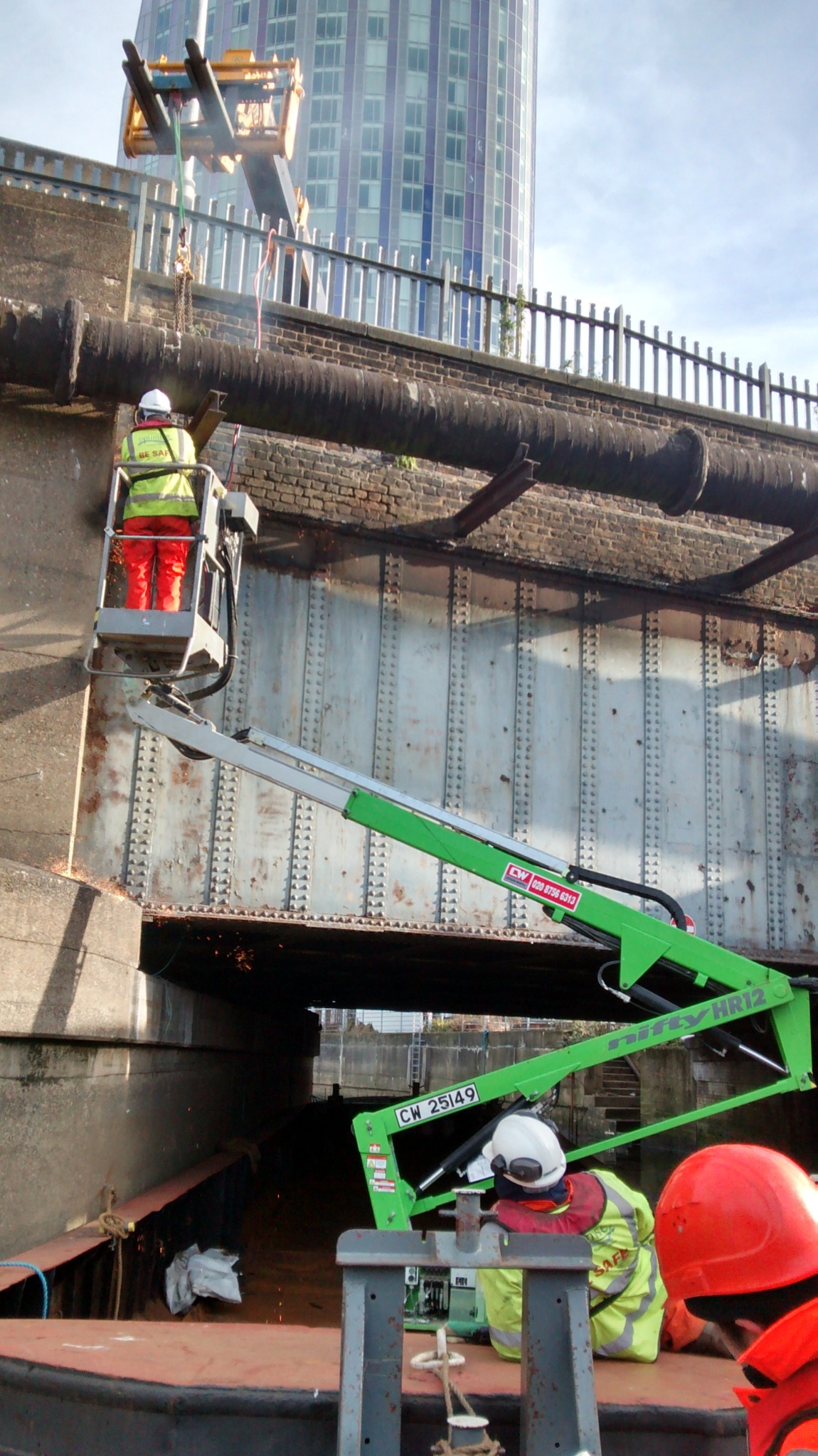 Mobile elevating work platform secured on a barge for inspection access