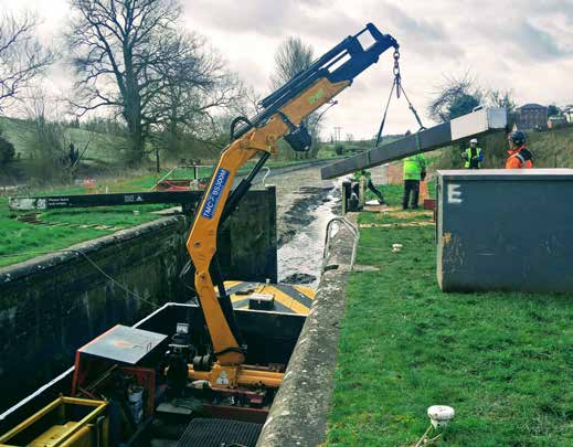 Jumbo specialist lock-repair barge working inside a lock