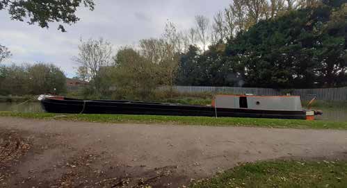 Historic narrow motor boat Barnet carrying material