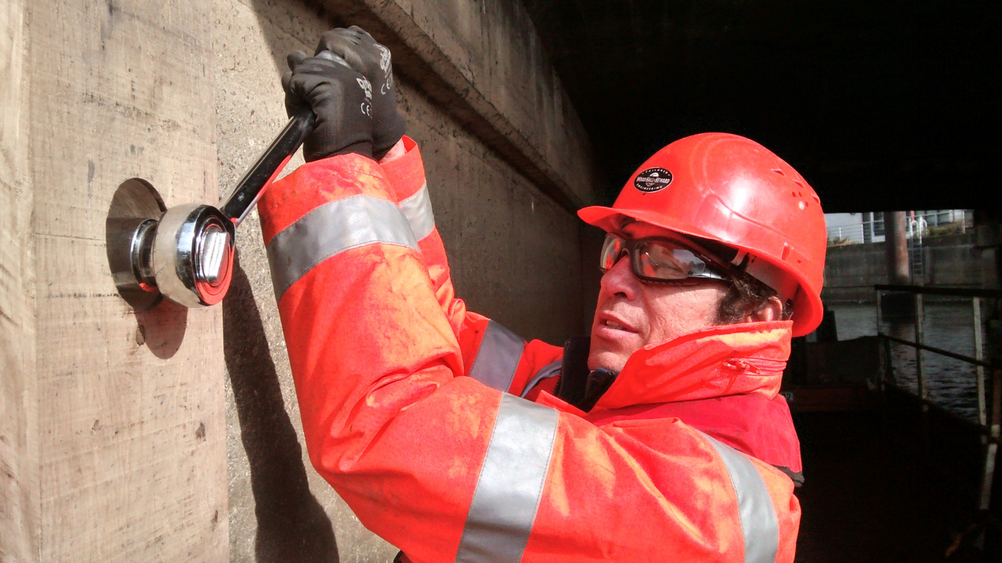 WHH crew member securing a bridge fender beneath a bridge structure