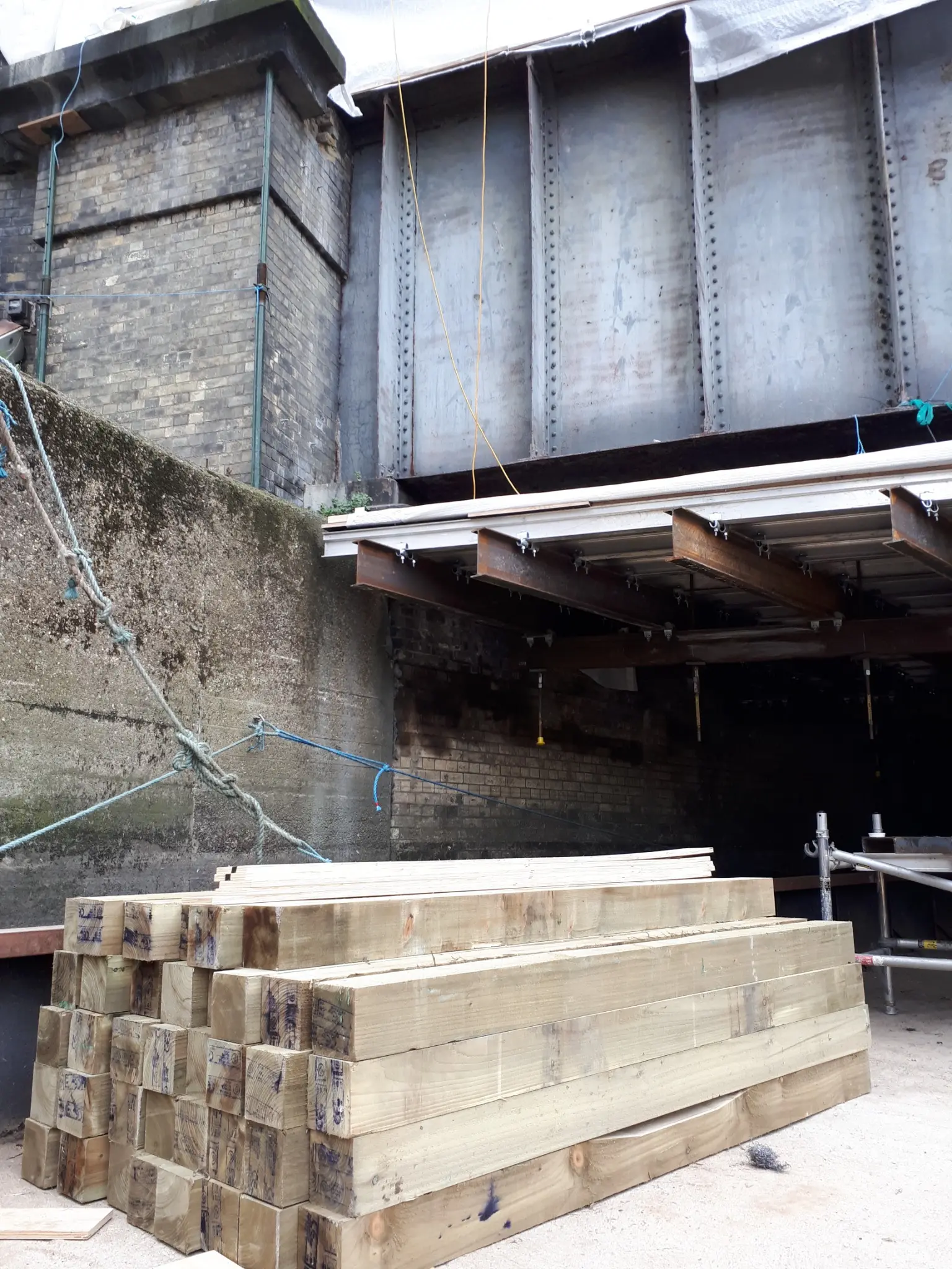 Timber and temporary works materials aboard Maud beneath the Northern Outfall Sewer Bridge