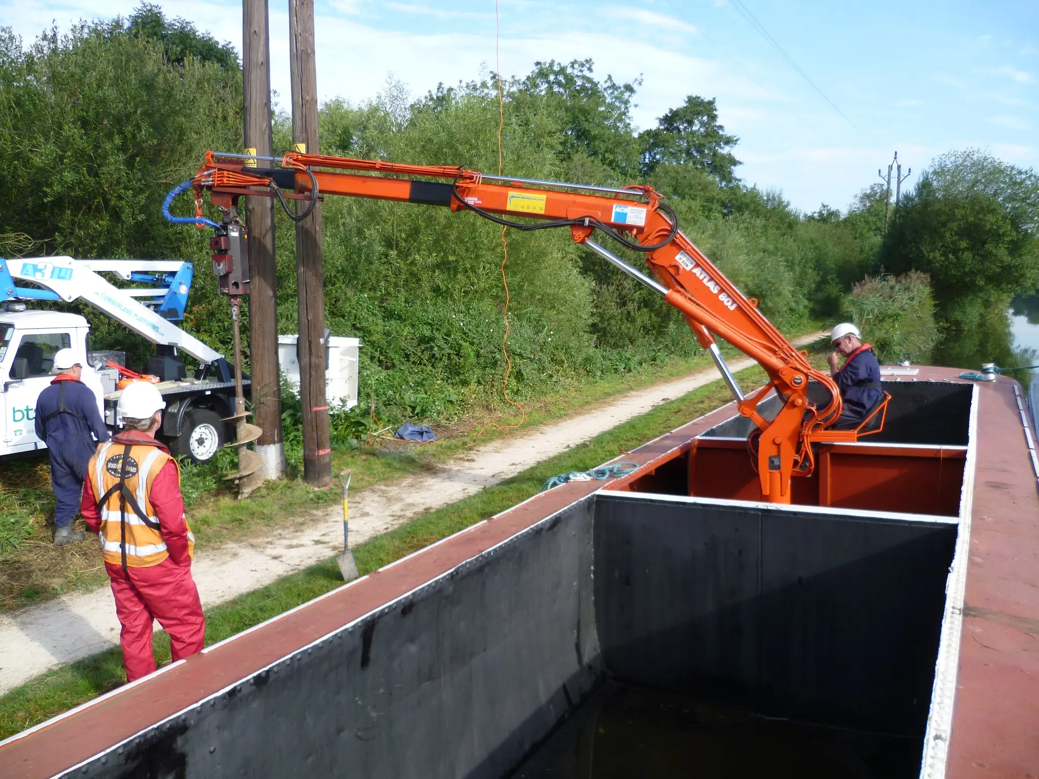 Barge-mounted hydraulic auger drilling an electricity pole foundation from Hippo on the River Lee