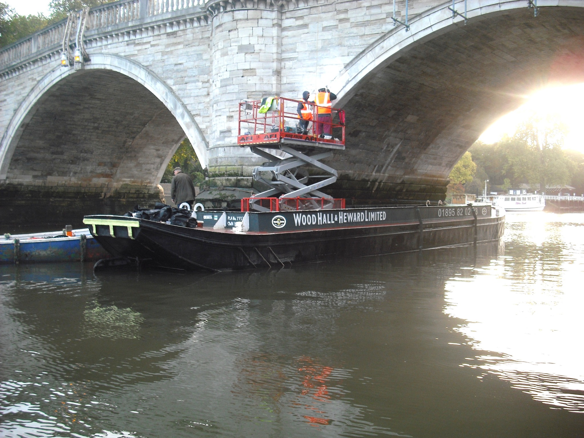 Scissor lift operating from a WHH barge beneath Richmond Bridge