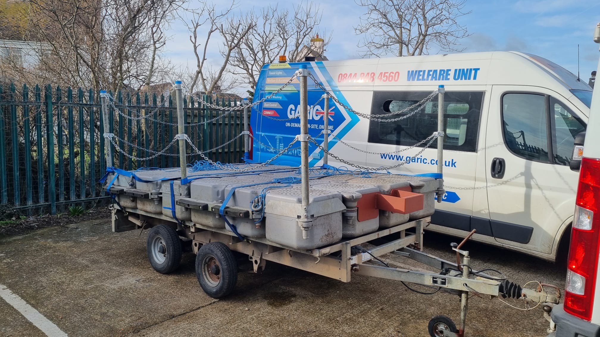 Compact modular pontoon with edge protection secured to a road trailer