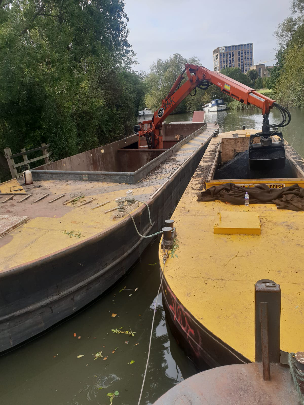 WHH crane boat Rhino unloading tarmac from a hopper beside the towpath