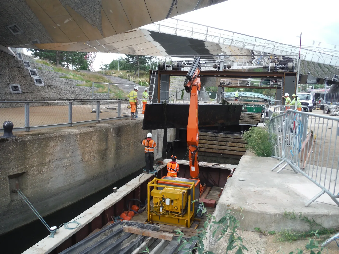 WHH crew operating a crane workboat in a constrained inland waterway structure